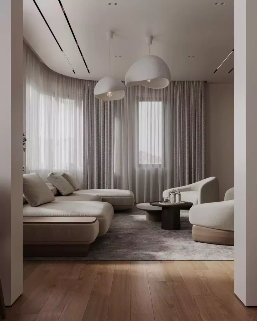 Salon minimaliste aux tons beiges avec canapé d'angle et grands rideaux, design d'intérieur Sevid Build